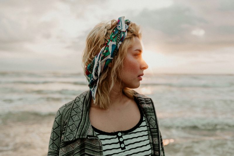 Woman with beach waves laughing on vacation
